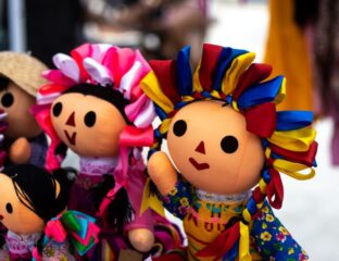 Colorful traditional dolls with bright floral headpieces and embroidered costumes.