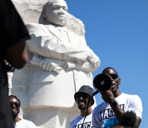 People take photos near the Martin Luther King Jr. Memorial statue.