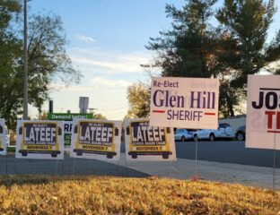 Yard signs for political candidates Glen Hill and Latee in a residential area.