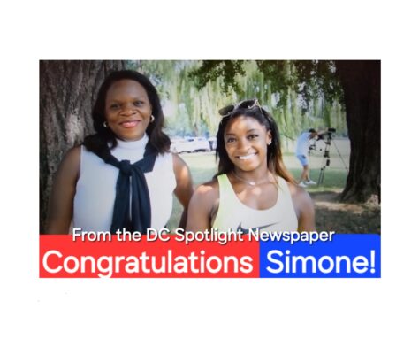 Two women smiling outdoors with a congratulatory message for Simone.