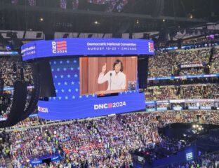 Speaker addressing a large crowd at DNC 2024 event.