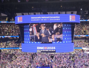 Speaker addressing a large crowd at the Democratic National Convention 2024.