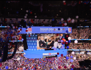 Celebration at the 2020 Democratic National Convention with balloons and a large crowd.